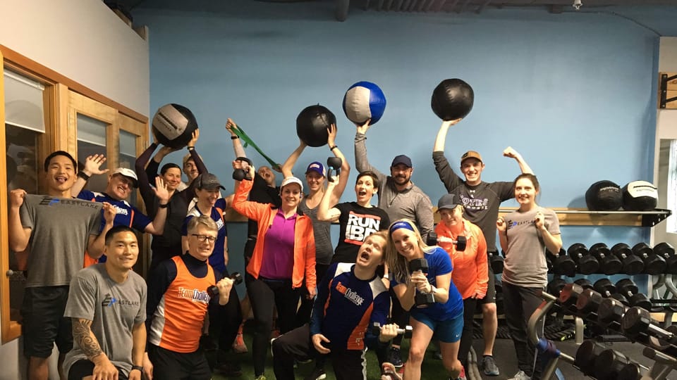 Clients and coaches gathered on the turf at an Eastlake Performance studio event.
